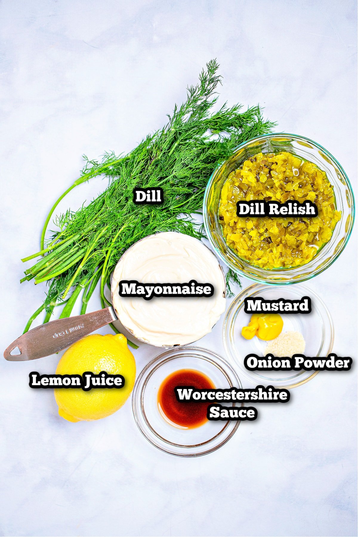 Individual ingredients for this easy tartar sauce recipe on a table.