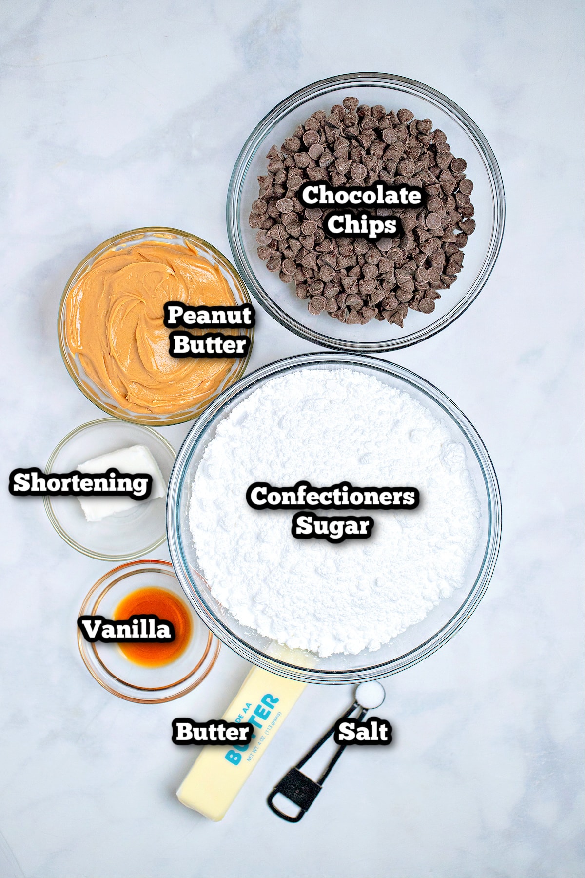 Individual ingredients for chocolate covered peanut butter balls on a table.