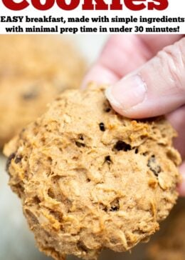 Pinterest pin with a hand holding an oatmeal breakfast cookie in full focus, over a sheet pan with other cookies in the background.