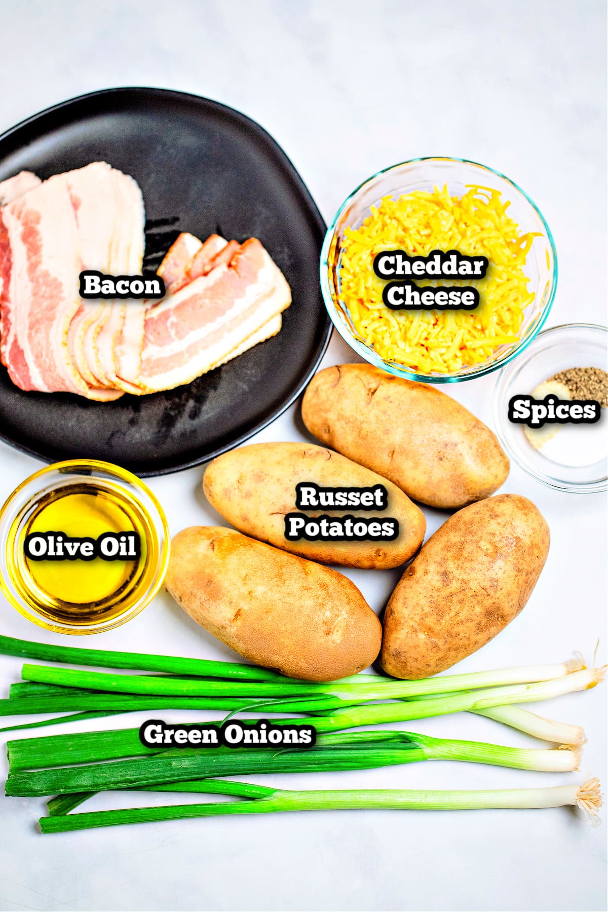 Individual ingredients for air fryer potato skins on a table.