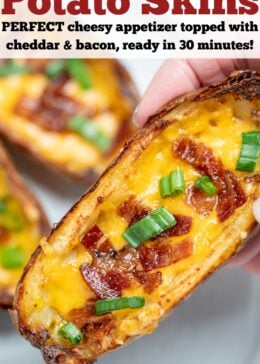 Pinterest pin with a hand holding a potato skin above a plate of more potato skins.