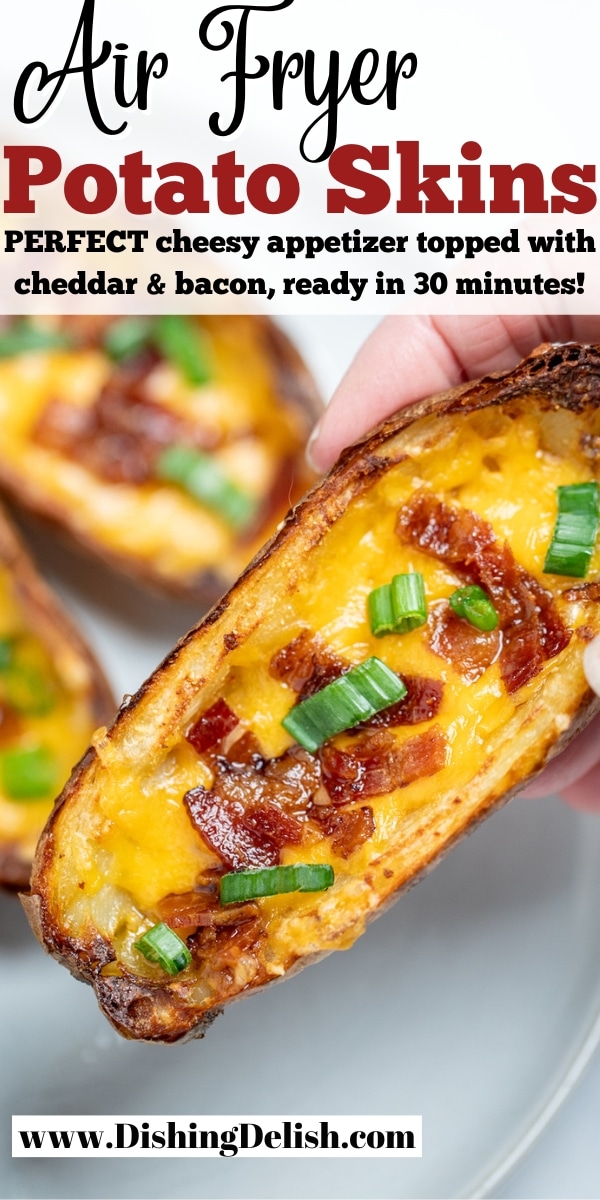 Pinterest pin with a hand holding a potato skin above a plate of more potato skins.