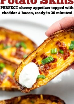 Pinterest pin with a hand holding a potato skin with sour cream above a plate of more air fryer potato skins.