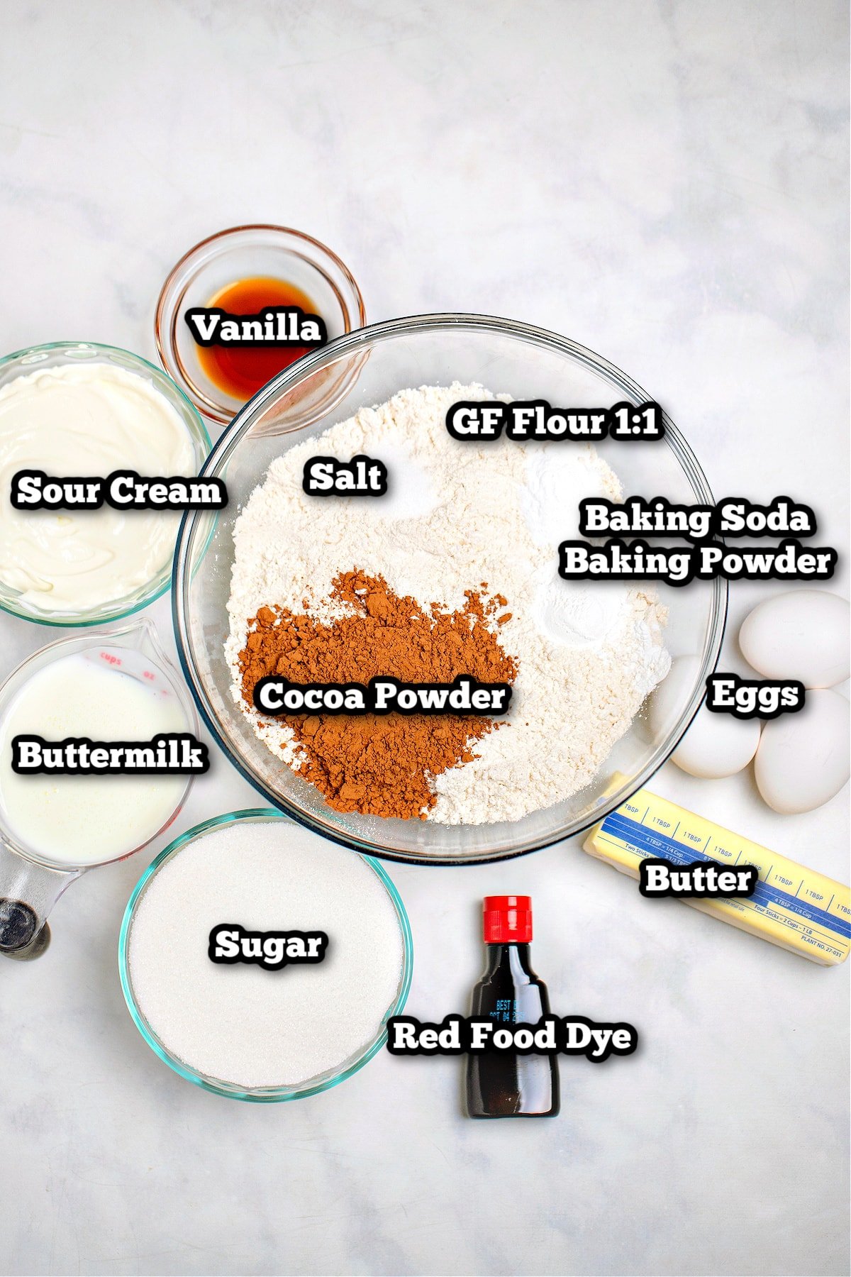 Individual ingredients for gluten free red velvet cake on a table.