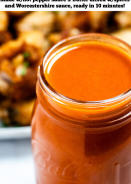 Pinterest pin with a jar full of homemade buffalo wing sauce in front of a plate of chicken wings.
