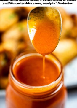 A pinterest pin with a jar of homemade buffalo wing sauce with a spoon over it, and a plate of wings in the background.