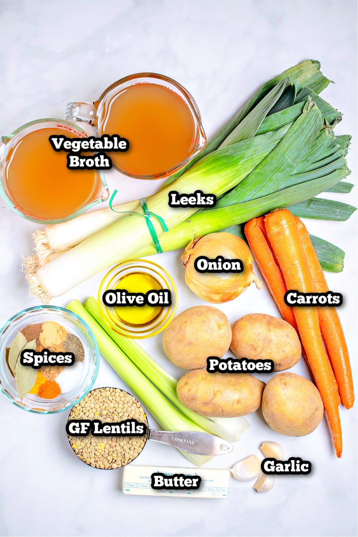 Individual ingredients for lentil vegetable soup on a table.