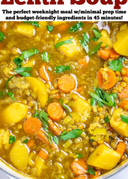 Pinterest pin with a dutch oven of lentil soup with carrots, potatoes, leeks, and lentils, topped with fresh chopped parsley.