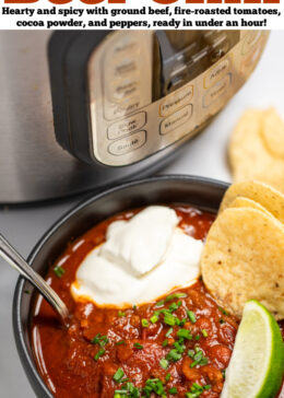 Pinterest pin with a bowl of chili with a spoon in it, topped with chopped chives, a lime wedge, and round tortilla chips, next to more lime wedges and tortilla chips, in front of an instant pot.