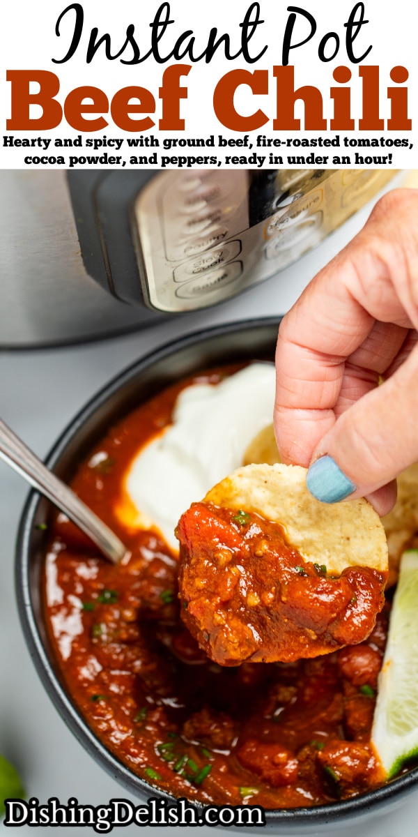 Pinterest pin with a bowl of chili with a spoon in it, topped with chopped chives, a lime wedge, and round tortilla chips, next to more lime wedges and tortilla chips, in front of an instant pot. A hand is holding a tortilla chip and scooping up chili.
