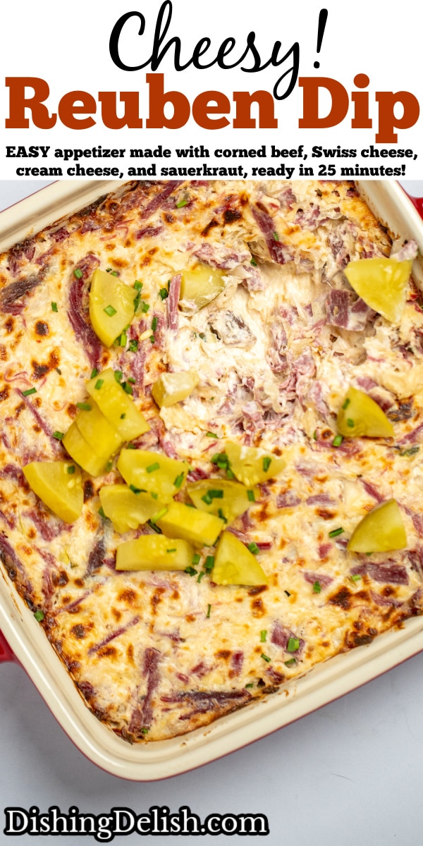 Pinterest pin with reuben dip topped with pickles in a baking dish on a table.