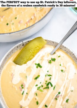 Pinterest pin with a spoon in a bowl of reuben soup on a table, topped with a pickle and a drizzle of Thousand Island dressing and chopped chives, in front of a dutch oven of soup.