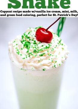 Pinterest pin with a tall glass of shamrock shake topped with whipped cream, sprinkles, and a cherry on top.