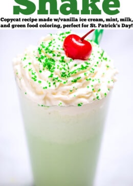 Pinterest pin with a tall glass of shamrock shake topped with whipped cream, sprinkles, and a cherry on top.