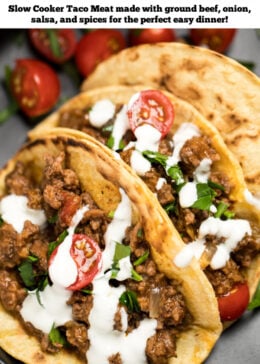 Pinterest pin with three beef tacos on a plate with cherry tomatoes, cilantro, and sour cream drizzled on top.