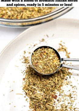 Pinterest pin with a measuring spoon with a scoop of Italian Seasoning from a bowl of herbs and spices, on a plate with the spice blend spilling out.