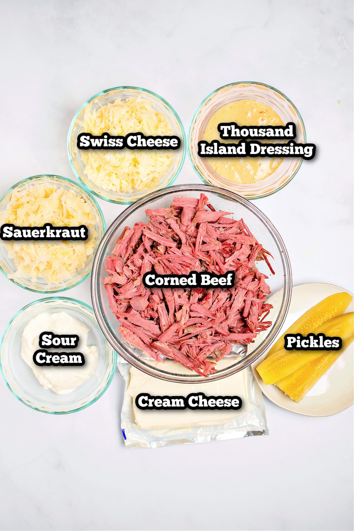 Individual ingredients for hot reuben dip on a table.