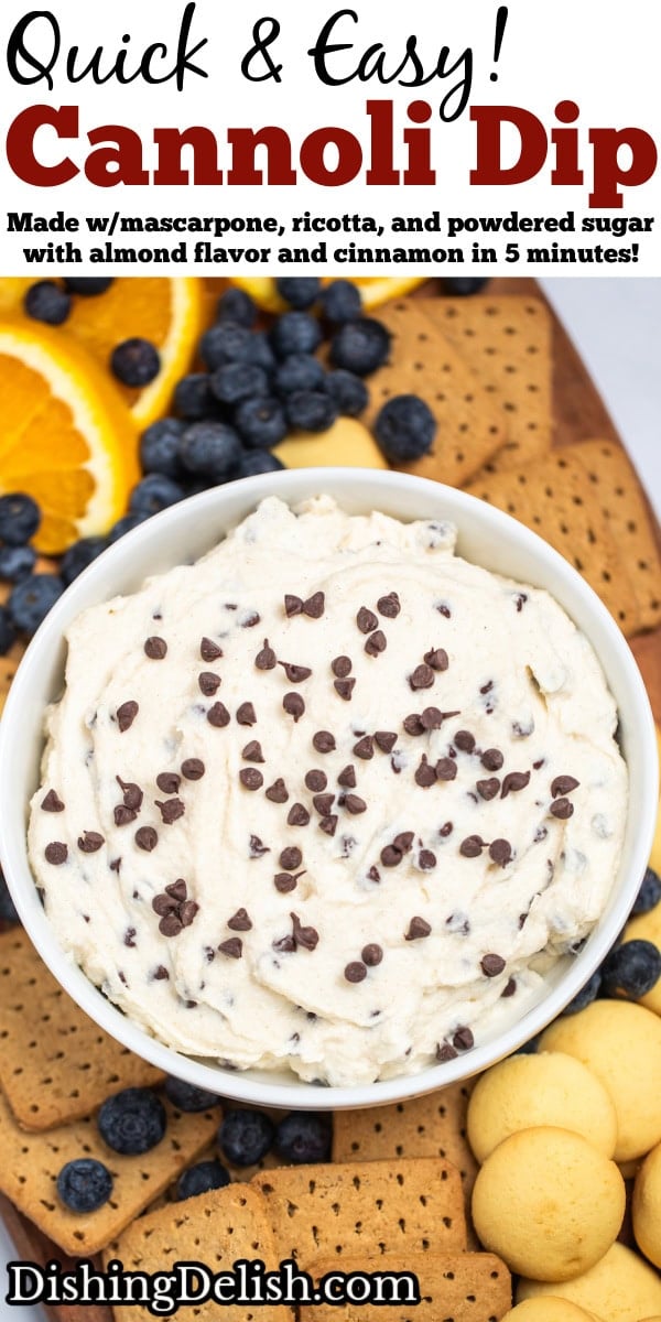 Pinterest pin with a bowl of cannoli dip topped with mini chocolate chips on a cutting board surrounded by graham crackers, vanilla wafers, blueberries, and orange slices.