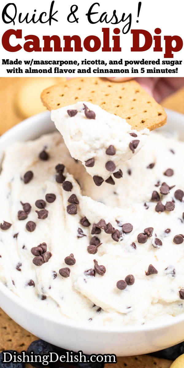 Pinterest pin with a bowl of cannoli dip topped with mini chocolate chips, with a hand using a graham cracker to scoop up some dip. The bowl is sitting on a cutting board surrounded by graham crackers, blueberries, and vanilla wafers.