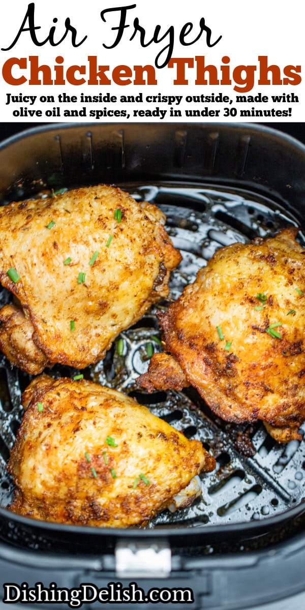 Pinterest pin with chicken thighs in an air fryer basket with chopped chives on top of crispy skin.