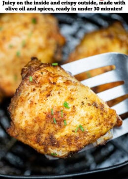 Pinterest pin with chicken thighs in an air fryer basket with chopped chives on top of crispy skin, with a spatula lifting one up.