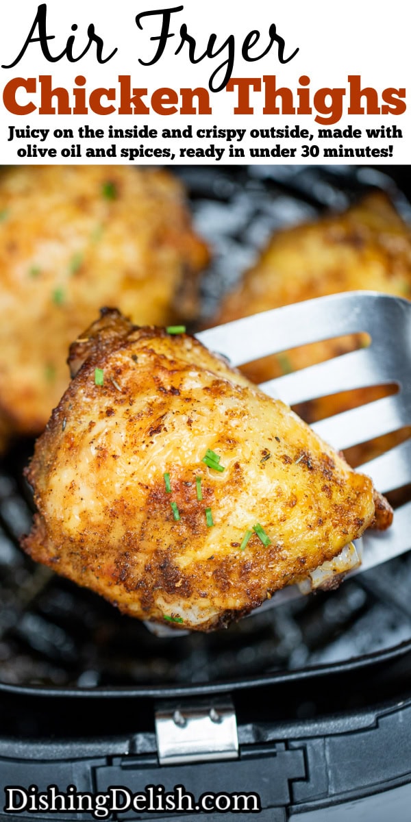 Pinterest pin with chicken thighs in an air fryer basket with chopped chives on top of crispy skin, with a spatula lifting one up.