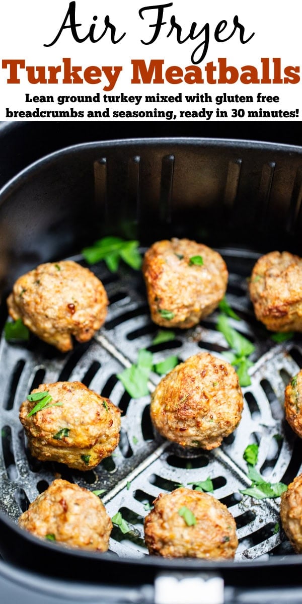Pinterest pin with air fryer turkey meatballs in an air fryer basket after being cooked. They're brown and caramelized and topped with fresh parsley.