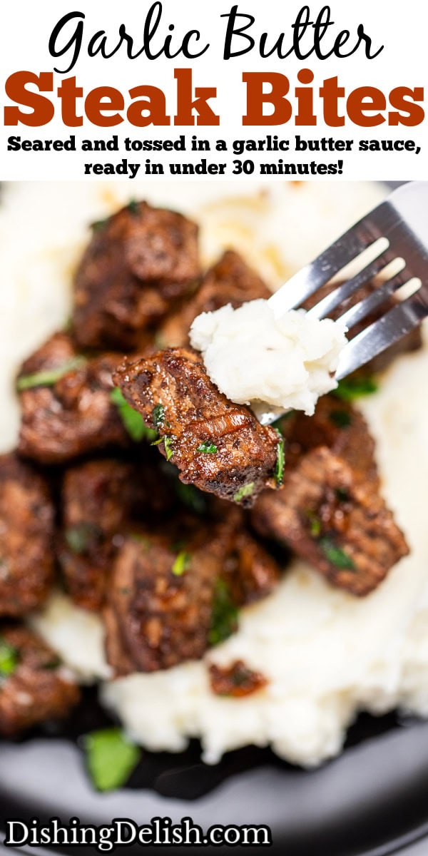 Pinterest pin with a plate of mashed potatoes topped with garlic butter steak bites topped with fresh parsley, with a fork lifting up potatoes with a piece of steak.