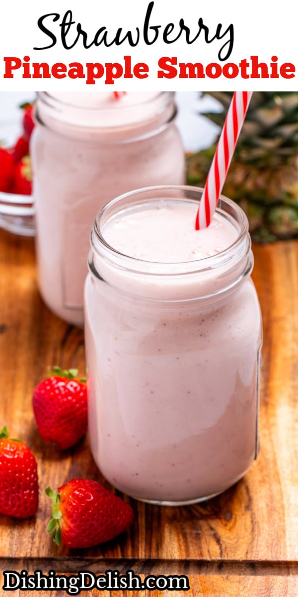 Pinterest pin with two mason jars sitting on a wooden cutting board with strawberry pineapple smoothie in them with a straw, next to strawberries and a pineapple top.