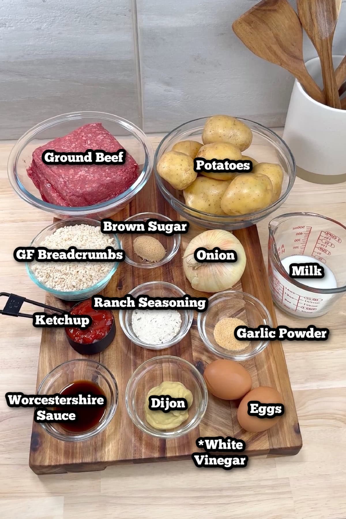 Individual ingredients for slow cooker meatloaf on a cutting board on the kitchen counter.