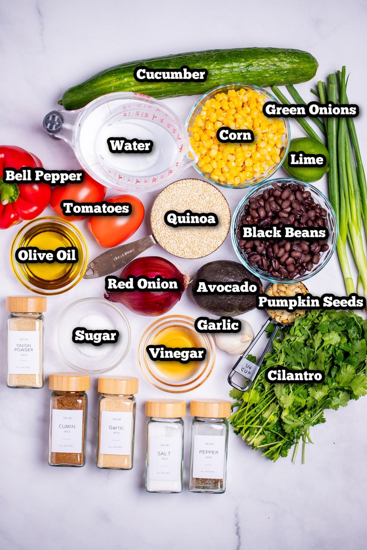 Individual ingredients for black bean quinoa salad on a table.