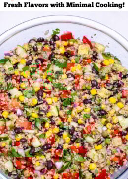 Pinterest pin with a bowl of black bean quinoa salad topped with fresh cilantro on a table.