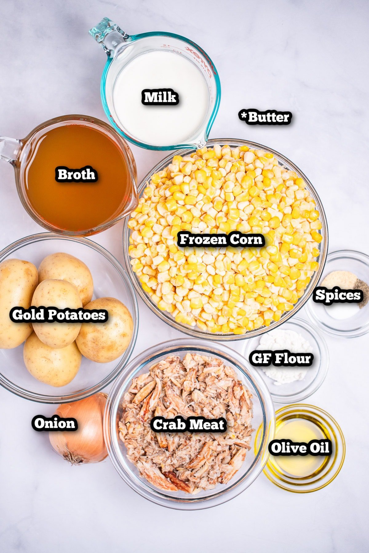 Individual ingredients for crab and corn chowder on a table.
