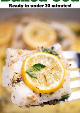 Pinterest pin with a baking dish with four cooked cod fillets, topped with lemon slices and fresh parsley, and in a lemon butter sauce. A spatula is lifting up one of the cod pieces.