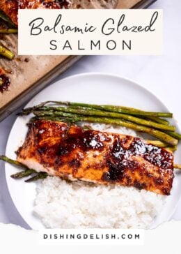 Pinterest pin with a plate with a balsamic glazed salmon fillet resting on top of rice and asparagus, with a sheet pan in the background.