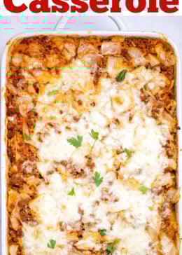 Pinterest pin with a casserole dish with Cabbage Roll Casserole topped with mozzarella cheese and fresh parsley before being served.