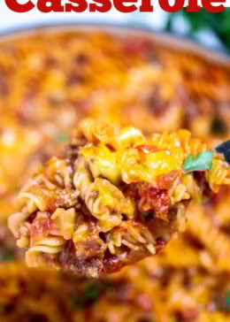 Pinterest pin with a spoon lifting cheeseburger casserole out of a skillet, topped with fresh parsley.