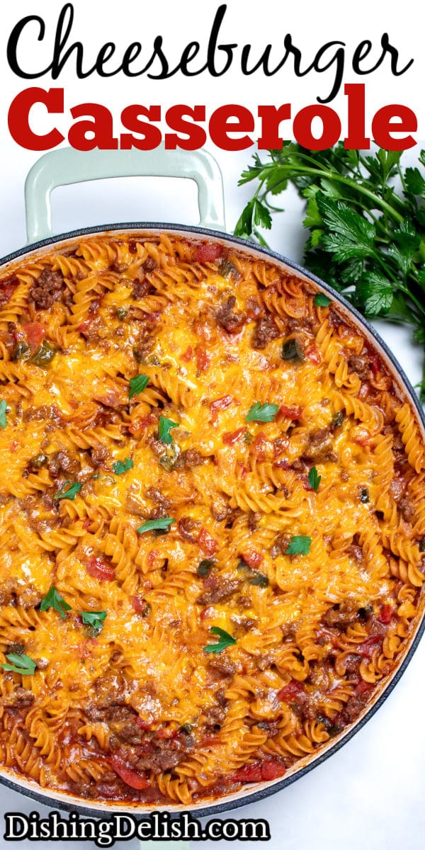 Pinterest pin with a cheeseburger casserole skillet with ground beef, gluten free rotini pasta, peppers, and onion topped with cheddar cheese and broiled, then topped with fresh parsley. There's fresh parsley on the table next to the skillet.