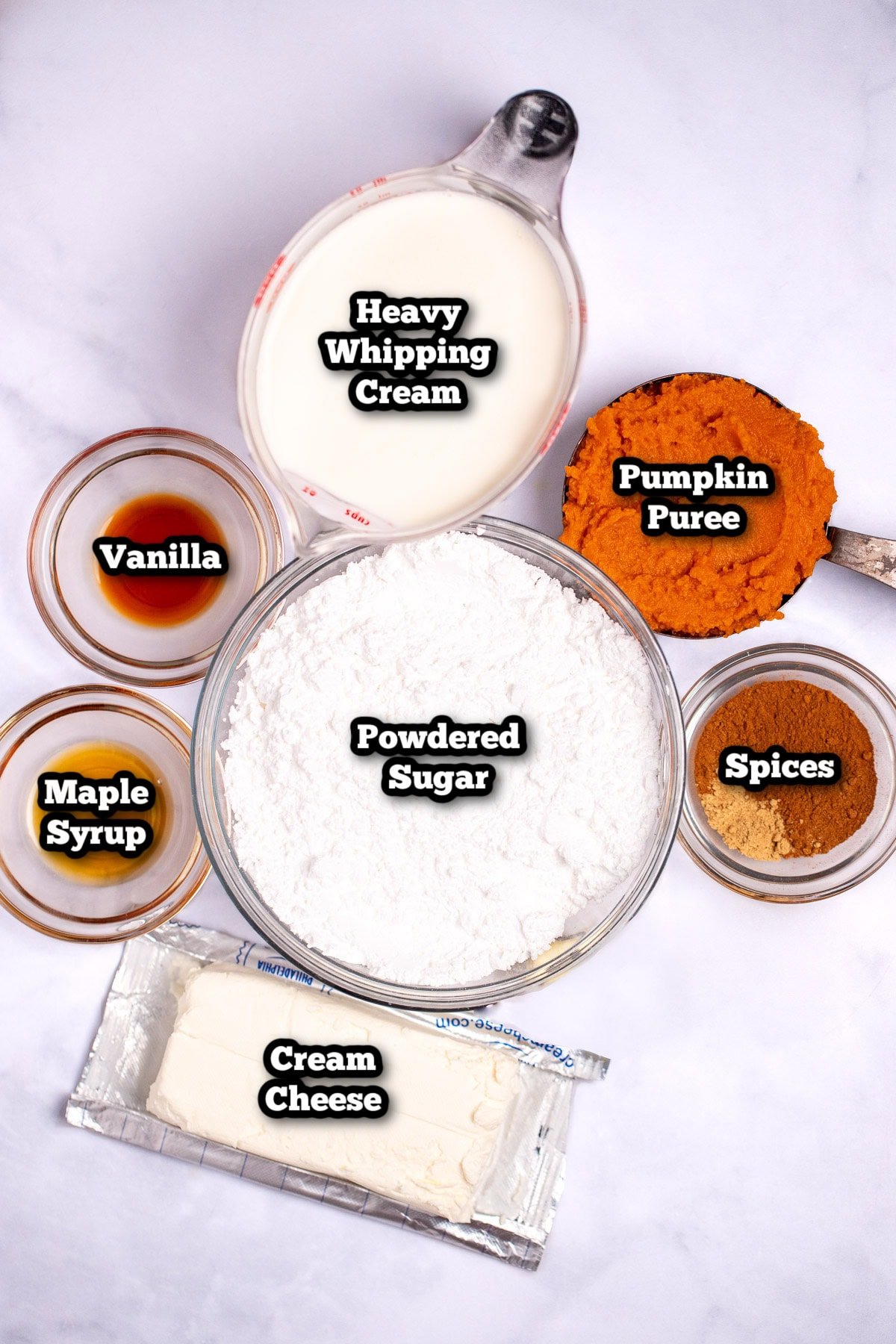 Individual ingredients for pumpkin dip on a table.