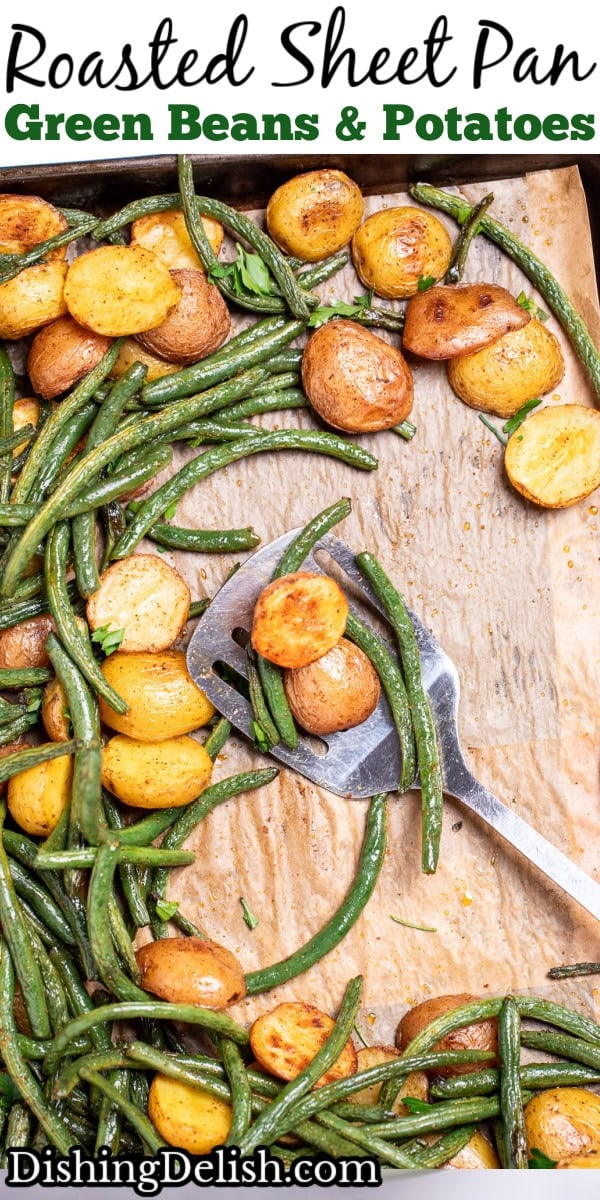 Pinterest pin with a sheet pan lined with parchment paper with roasted green beans and potatoes with olive oil and spices, topped with fresh parsley, and a spatula resting on the sheet pan.