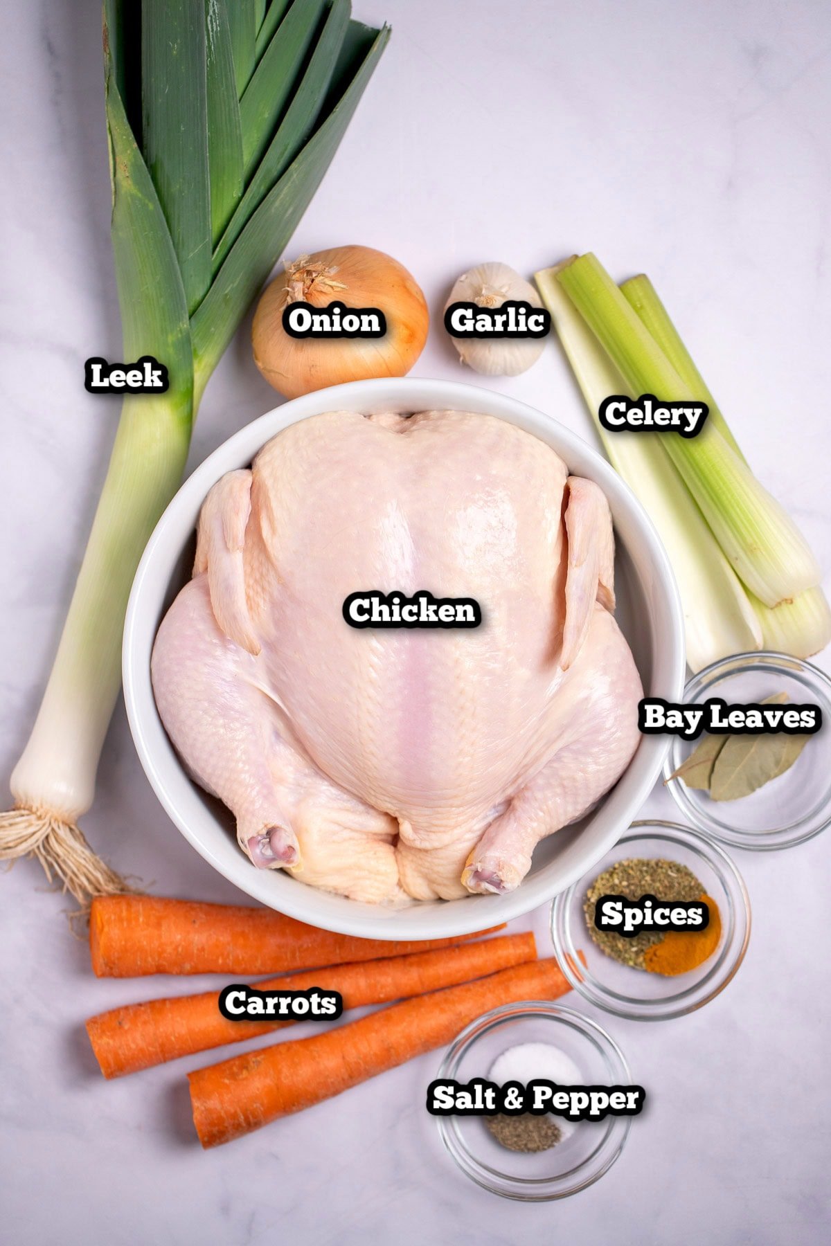 Individual ingredients for slow cooker chicken soup on a table.