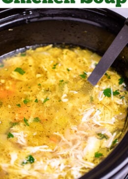 Pinterest pin with a slow cooker of chicken soup topped with fresh parsley with a ladle in it ready to serve.