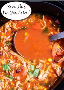Pinterest pin with a slow cooker full of chicken tortilla soup topped with fresh cilantro and a ladle resting in the soup.