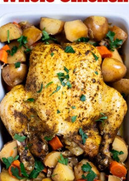 Pinterest pin with a whole chicken, broiled until crispy, resting on top of potatoes and carrots in a baking dish, topped with fresh parsley.