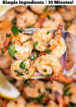Pinterest pin with a nonstick skillet with cooked shrimp in garlic and butter with fresh parsley and two lemon wedges in the skillet, with a spatula lifting some up.