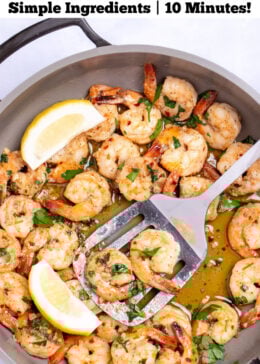 Pinterest pin with a nonstick skillet with cooked shrimp in garlic and butter with fresh parsley and two lemon wedges in the skillet, with a spatula holding some shrimp and resting in the skillet.