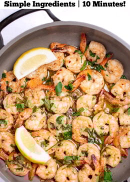 Pinterest pin with a nonstick skillet with cooked shrimp in garlic and butter with fresh parsley and two lemon wedges in the skillet.