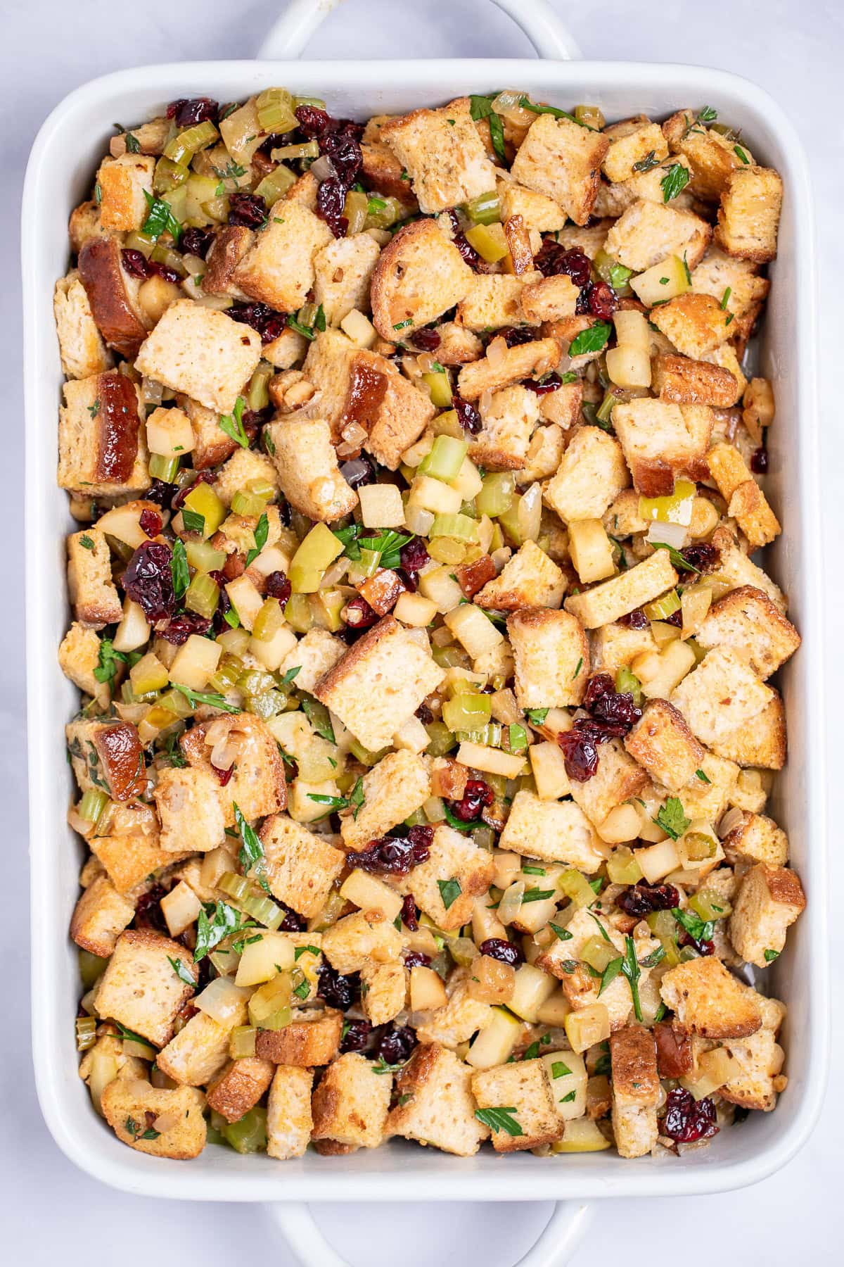 A baking dish with gluten free stuffing before being baked.