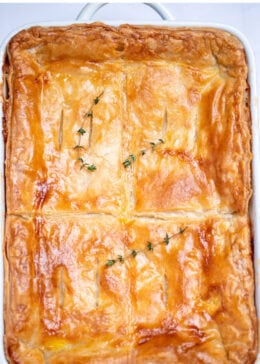 Pinterest pin with a baking dish of leftover turkey pot pie casserole with a golden brown puff pastry top.