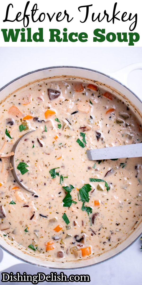 Pinterest pin with delicious homemade creamy leftover turkey and wild rice soup garnished with fresh parsley in a dutch oven, with a ladle resting in the soup.